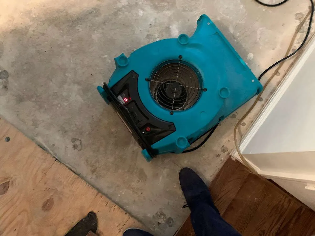Air mover drying subfloor during Leak Detection & Repair in Greensboro